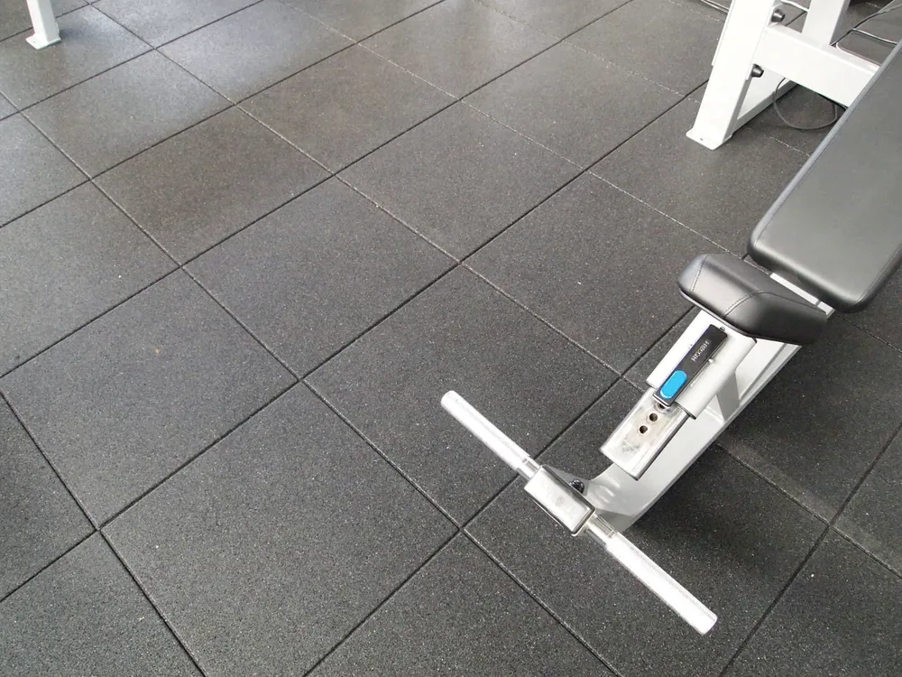 ECO-GYM TOP 4 Détail des plaques ECO-GYM TOP à côté d'un banc de musculation