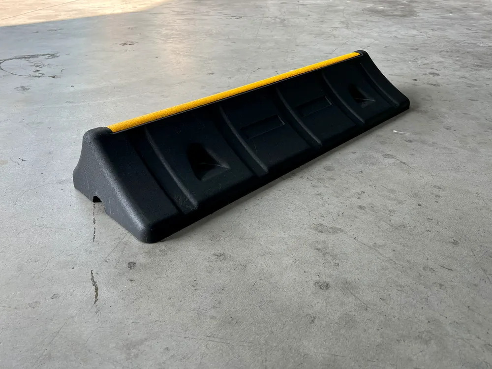 ECO-TRUCK STOP wheel chock made of recycled rubber with a reflective strip, shown in perspective